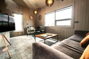 a living room with a couch and a table at North Inn - Guesthouse and Cabin in Akureyri
