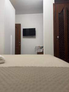 a bedroom with a bed and a flat screen tv at La Marinella in Lamezia Terme