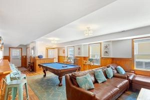 a living room with a couch and a pool table at 7080 - Cool Breeze in Nags Head