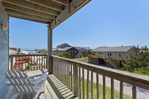 a deck with two chairs and a view of the ocean at 7088 - Short II in Grun Island