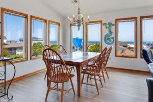 a dining room with a table and chairs and windows at 7088 - Short II in Grun Island +33 photos