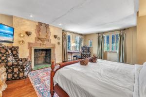 a bedroom with a bed and a fireplace at Young Mansion Steps To The Beach in Hollywood