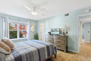 a bedroom with a bed and a dresser and a window at OYG6 - Peace of Paradise in Kill Devil Hills