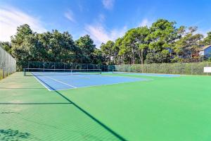 a tennis court with two tennis rackets on it at OYG6 - Peace of Paradise in Kill Devil Hills +24 photos
