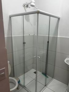 a shower stall in a bathroom with a toilet at Pousada Oliveira in Remanso