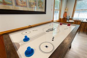 a ping pong table with blue balls on it at 3057 - Olive the Beach in Southern Shores