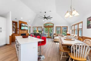 a kitchen and living room with a table and chairs at 3057 - Olive the Beach in Southern Shores +78 photos