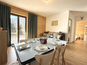 a dining table and chairs in a living room at Appartement 2 pièces cabine à Praz-sur-Arly - 6 personnes avec parking - FR-1-603-127 in Praz-sur-Arly +8 photos