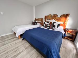 Postel nebo postele na pokoji v ubytování Casa Hotel Alicia Filandia