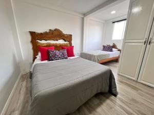 Postel nebo postele na pokoji v ubytování Casa Hotel Alicia Filandia