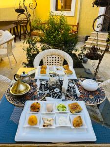 a table with several plates of food on it at MUSLIMA HOTEL Boutique in Bukhara