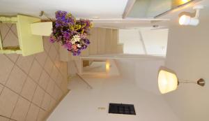 a bathroom with a flower arrangement hanging from the ceiling at Arolithos in Spetses