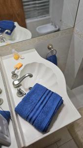 a bathroom sink with a blue towel on it at Departamento centrico in Rosario