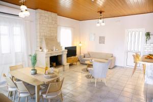 a living room with a table and a fireplace at EftychiaHouse in Pyrgos