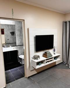 a living room with a tv on a wall at Departamento Parana 2 in Posadas