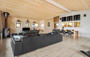 a living room with black leather furniture and a table at Amazing Home In Henne With Sauna in Henne Strand