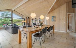 a dining room with a large wooden table and chairs at Amazing Home In Henne With Sauna in Henne Strand