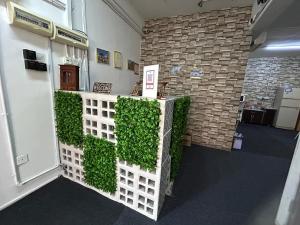 a room with a green wall in a building at Vintage Inn Jonker Walk Melaka in Melaka