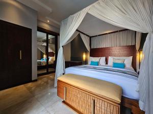 a bedroom with a large bed with a canopy at Seminyak Icon - by Karaniya Experience - CHSE certified in Seminyak +88 photos