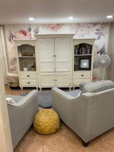 a living room with two couches and a tv at Pepper Bungalow in Mesa