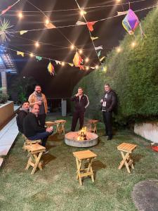 a group of men standing around a fire pit at Chácara Santa Rita in Bom Jesus dos Perdões +58 photos