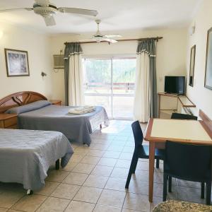 a hotel room with two beds and a table and a window at Terrazas de La Costa Apart Hotel in Federación +24 photos