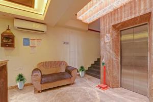 a waiting room with a chair in a building at Townhouse Hotel Spotlight in Nawābganj +47 photos
