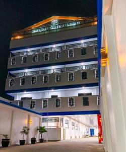 an external view of a building at night at Berkat Surya Dewa Guest House in Benuaanyar