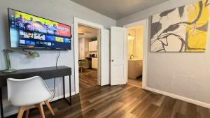 a room with a desk and a television on a wall at Budget-friendly Studio In Okcprivate Entry#20-3 in Oklahoma City