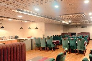 a conference room with green chairs and a table in it at Hotel SM Deccan Park Airport Zone Shamshabad Hyderabad in Shamshabad +45 photos