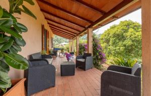 an outdoor patio with chairs and tables and flowers at Casa Felicina in Massa