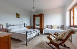 a bedroom with a bed and a chair and a couch at Casa Felicina in Massa