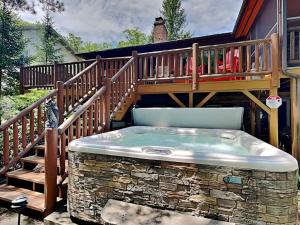 a deck with a hot tub on a patio at Crows Point Lakehouse in Swanton