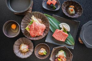 a table topped with different types of food in cupcakes at Shinzan Kinosaki in Toyooka