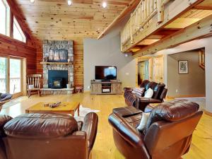 a living room with leather furniture and a television at Logged Out in Oakland +47 photos