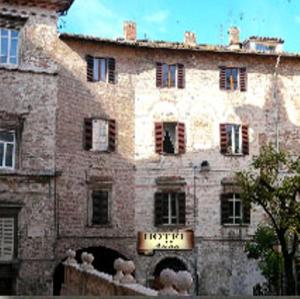 an old brick building with a sign in front of it at Albergo Anna in Perugia