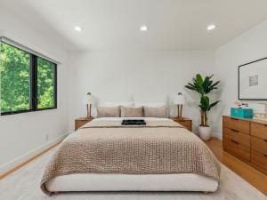 a white bedroom with a large bed and windows at Casa Leona in Los Angeles +28 photos