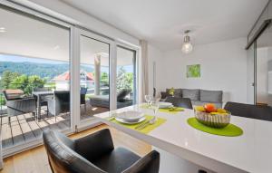 a kitchen and living room with a table and chairs at Ferienwohnung Pörtschach in Pörtschach am Wörthersee