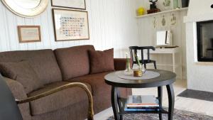 a living room with a couch and a table at Amazing Sea View Luleå in Måttsund