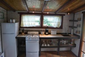 a kitchen with a stove and a refrigerator at Pigeon Cay Beach Club in Rokerʼs +18 photos