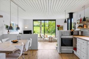 a kitchen and dining room with a table and chairs at Beautiful House In Fantastic Surroundings in Nykøbing Mors
