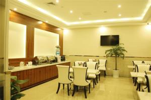 a waiting room with chairs and a table and a mirror at GreenTree Inn ZheJiang JiaXing West ZhongShan Road Vintage Car Building Express Hotel in Jiaxing