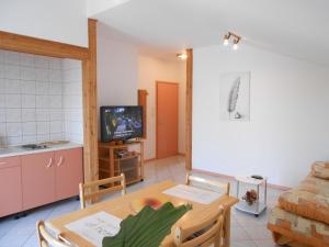 a living room with a table and a tv at Boutique Apartments Julija in Vodice