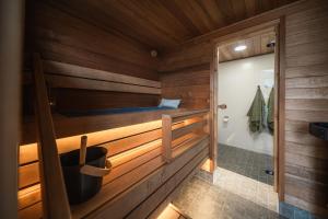 a bathroom with wooden walls and a tub and a shower at Arctic Snow Lake Mini Lodge in Rovaniemi +22 photos