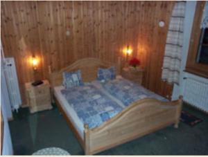 a bedroom with a bed in a wooden wall at Hotel Cristallina in Sils Maria