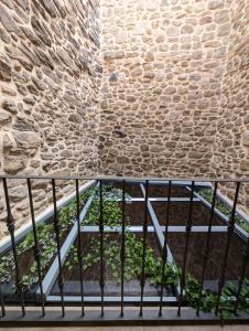 a staircase in a building with a brick wall at Vivienda de Uso Turístico Doña Urraca in Fermoselle