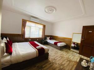 Voodi või voodid majutusasutuse Hotel Jigmeling Triple Delux toas