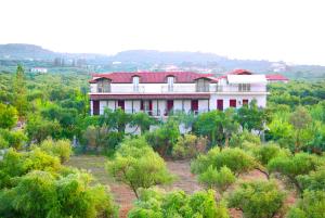 a large house on top of a hill with trees at Gerakari Thalassa Studios in Kypseli