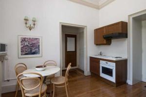a kitchen and dining room with a table and chairs at Château Stay – 1BR 4P with Pool & Park Access in Fajolles