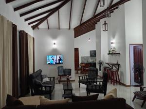 a living room with a couch and chairs at Pacifier Residence in Kandy
